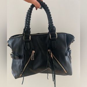 black leather two handle bag purse with zippers and buckles. Gold hardware.